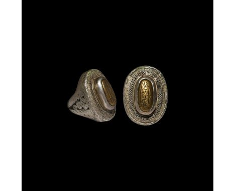 18th-19th century AD. A substantial hollow-formed finger ring with applied filigree knotwork and ropework scrolls to the hoop