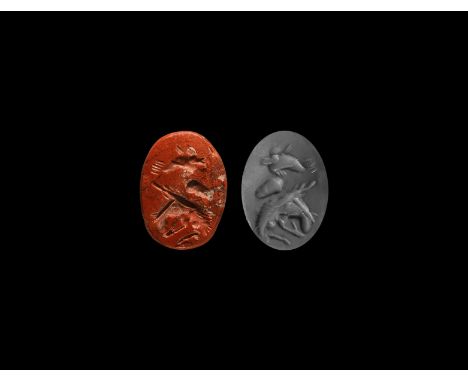 2nd-3rd century AD. An oval red jasper intaglio gemstone engraved with an enigmatic sea creature and dolphin.   0.69 grams, 1