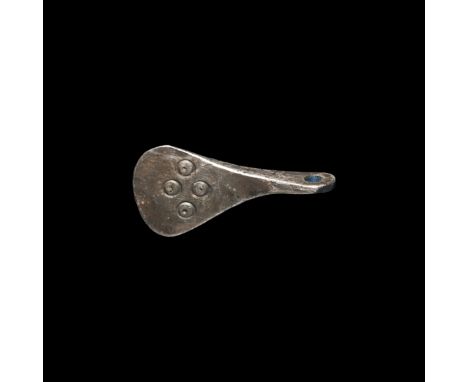 9th-11th century AD. A silver broad axe pendant with integral suspension loop, one side with stamped ring-and-dot decoration.