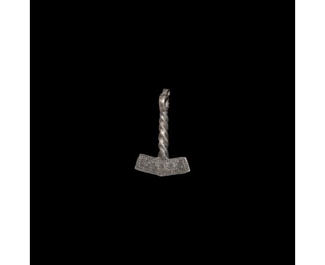 9th-11th century AD. A silver pendant formed as a hammer with twisted handle, the hammer with punched pellets-in-triangle mot