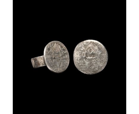 6th-7th century AD. A silver finger ring with flat-section hoop and disc bezel; incised image to the bezel of a facing nimbat