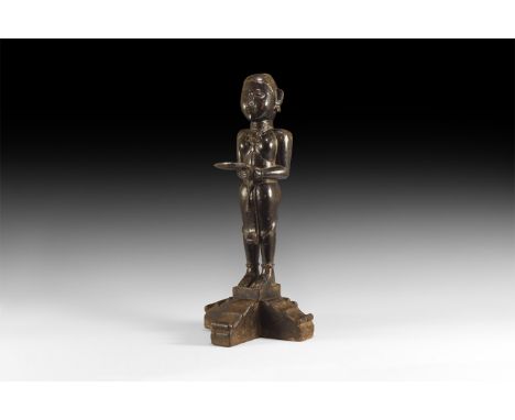 18th-19th century AD. A dark wooden statue of a deity standing, possibly Shakyamuni Buddha with his alms bowl (bhikshu), stan