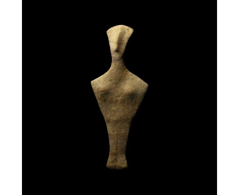 4th-3rd millennium BC. A fine grained marble figure of a stylised female; flat, fan-shaped head with long prominent nose ridg