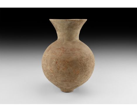 2nd millennium BC. A ceramic jar with globular body, narrow base, trumpet-shaped mouth, traces of red pigment.   2.6 kg, 33cm