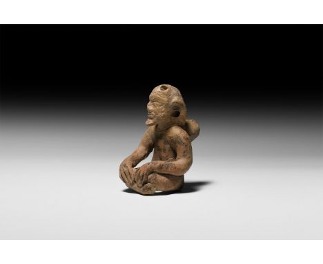 3rd-7th century AD. A seated cross legged figure with hands placed on knees; prominent facial features with almond-shaped eye
