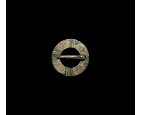 13th-15th century AD. A bronze ring brooch with round-section pin and decorated outer face.   0.94 grams, 18mm (3/4"). Proper