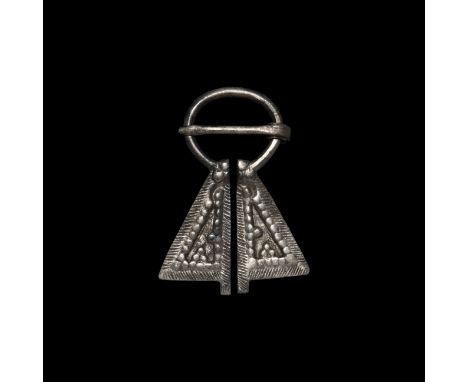 12th-14th century AD. A Viking inspired silver omega brooch with hatched borders and faux granule detail to both flanges. See