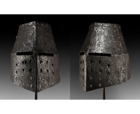 Early 14th century AD. An impressive iron great helm of later typology, composed of five plates rivetted together; T-shaped n