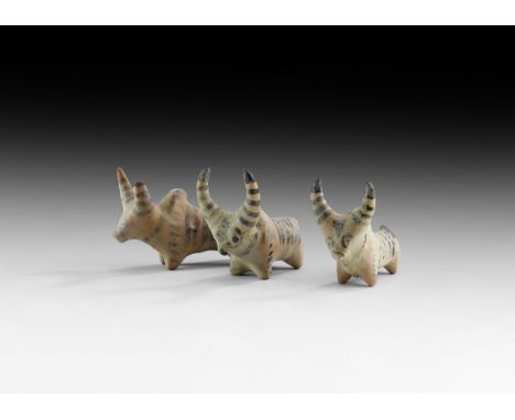 4th-2nd millennium BC. A group of three ceramic zebu figurines with painted linear detailing; one with broken horn.   229 gra
