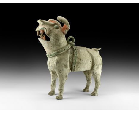 Han Dynasty, 206 BC-220 AD. A substantial hollow-formed ceramic guardian figure of a terrier dog standing with splayed claws,