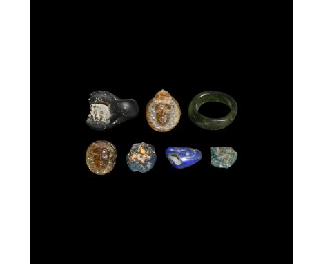 1st century BC-1st century AD. A collection of two blue glass amulets in Egyptian style; a glass green ring; two fragments of