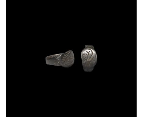 13th-14th century AD. A bronze flat-section ring with expanding shoulders and oval bezel engraved with a standing eagle with 