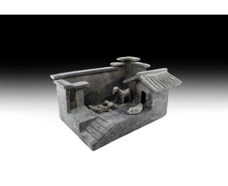 Han Dynasty, 206 BC-220 AD. A ceramic model farmyard with walled enclosure, roofed shelter, raised steps, six animals includi
