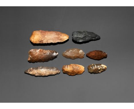 Neolithic, 4th-2nd millennium BC. A group comprising: a small bifacial knapped axe with convex cutting edge; two points (a sl