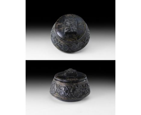 8th-10th century AD. A carved schist squat jar with separate lid, band of roundels to the chamfered sidewall each containing 