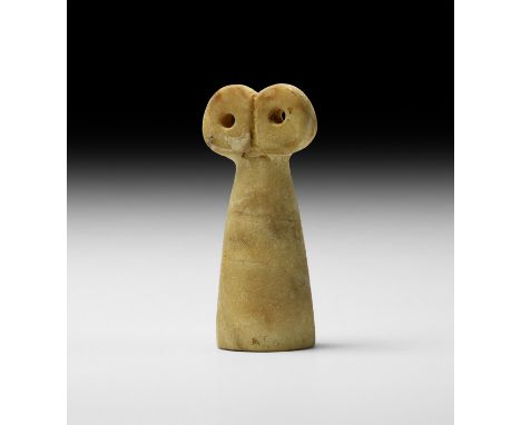 2nd millennium BC. A carved alabaster idol with conical trunk and two pierced disc eyes above.   29 grams, 53mm (2"). Propert