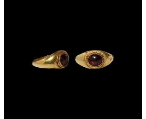 2nd-3rd century AD. A gold finger ring with cell to the plaque, inset garnet cabochon. Cf. Ruseva-Slokoska, L., Roman Jewelle