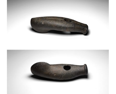 Neolithic, late 3rd-early 2nd millennium BC. A large and finely polished boat-shaped axe in dark grey stone, with expanded as