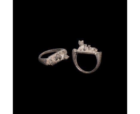 30 BC-323 AD. A silver finger ring, D-shaped in profile with flared shoulders, bezel with model of a reclining cat and two si