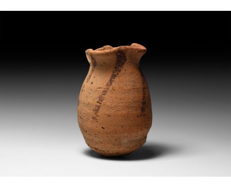Pre-Dynastic Period, 4th millennium BC. A coarse ceramic pot with rounded base, tapering body, rim pinched into four pouring 
