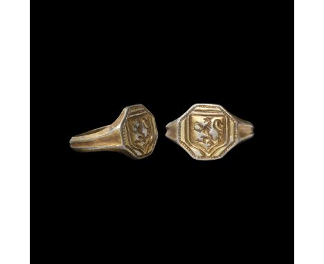 17th-18th century AD. A silver-gilt ring with grooved hoop, hexagonal bezel with a rampant lion within a shield.   6.19 grams
