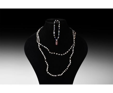 3rd millennium BC. A group of two restrung necklaces composed of white and black tubular stone beads, one with three facetted