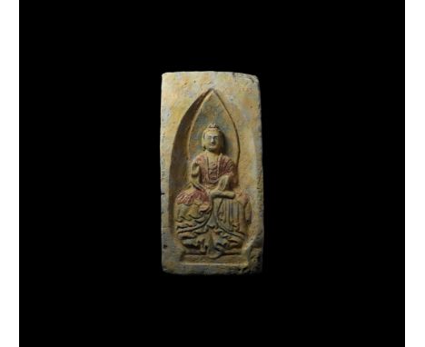Northern Wei Dynasty, 386-534 AD. A ceramic brick with recessed face, polychrome image of seated Buddha wearing voluminous ro