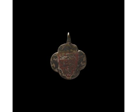 14th century AD. A bronze horse harness pendant formed as a quatrefoil panel with integral loop above, enamelled heater shiel