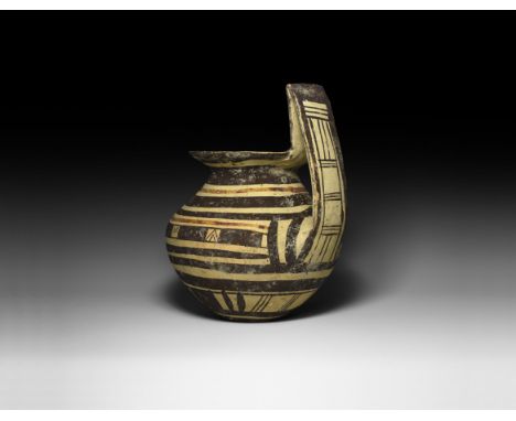 7th-5th century BC. A ceramic jar or krater with broad bulbous body, flared rim and high strap handle, geometric painted orna