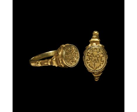 Late 16th-early 17th century AD. A gold merchant's signet ring with scrolls to the shoulders and bezel, incuse ornate heater 