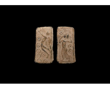 1st-3rd century AD. A rectangular lead plaque, one side with flying Victory holding a wreath, ring-and-dot decoration below; 