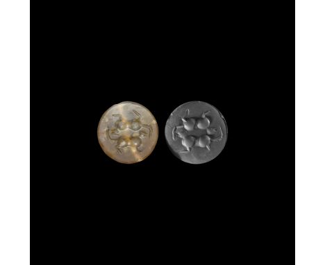 1st millennium BC. A plano-convex agate stamp seal with intaglio image of two felines placed tête-bêche; accompanied by a mus