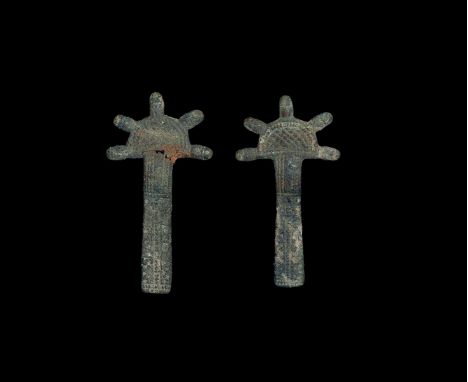 5th-6th century AD. A matched pair of radiate-headed brooches; each a D-shaped headplate with five lobed extensions, formed a