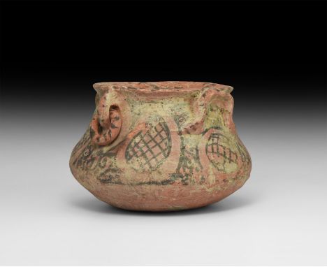2nd millennium BC. A squat ceramic bowl with carinated body, everted rim, applied loops beneath the rim and free-running ring