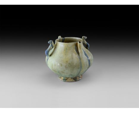 19th century AD or earlier. A glazed ceramic footed jar with broad bulbous body,two lateral handles formed as a regardant bea