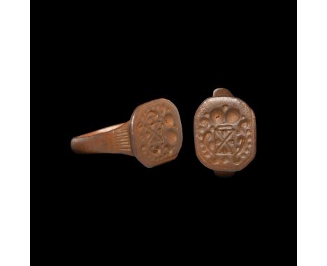 18th century AD. A bronze finger ring with heraldic motif, rectangular shield with saltire motif, crown above and pelletted f
