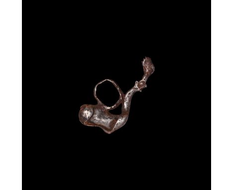 1st millennium BC. A silver pendant of a phallus with lateral ring and trumpet-shaped tail.   5.66 grams, 42mm (1 3/4"). Prop