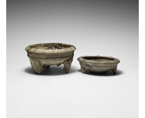 1st millennium AD. A group of two ceramic bowls, each with three stub feet and chamfered rim.   667 grams total, 12-15cm (4 3