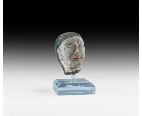 Han Dynasty, 206 BC-220 AD. A ceramic head, ribbed hair parted at the centre and continuing to the base of the neck, survivin