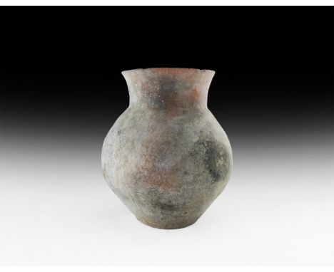 3rd-2nd millennium BC. A ceramic biconvex vessel with everted neck and flat base.   1.6 kg, 23.5cm (9 1/4"). From the propert
