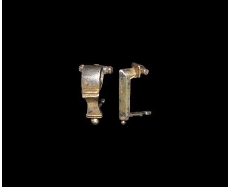 2nd century AD. A group of two silver-gilt knee brooches, one with rectangular headplate and right-angled bow, the other with