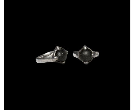10th-12th century AD. A silver ring with flat-section hoop, raised claw bezel inset with black glass cabochon; Eastern Europe