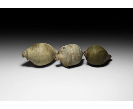 9th-11th century AD. A group of three hollow ceramic vessels each with conical body, intended to be filled with explosive liq