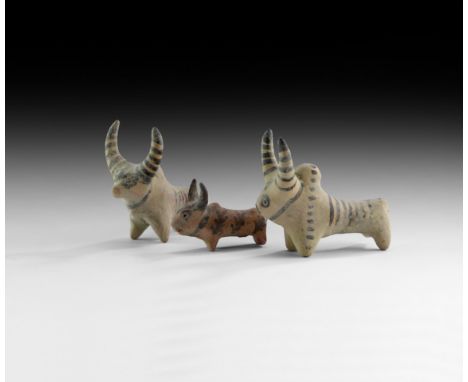 4th-2nd millennium BC. A group of three ceramic zebu figures, two with painted linear detailing, the smallest with painted le