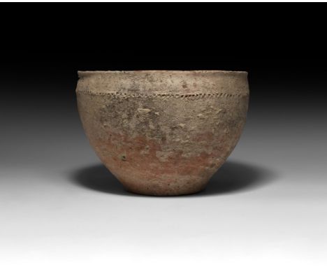 3rd millennium BC. A substantial ceramic bowl with narrow foot, band of impressed points below the rim.   1 kg, 21.5cm (8 1/2