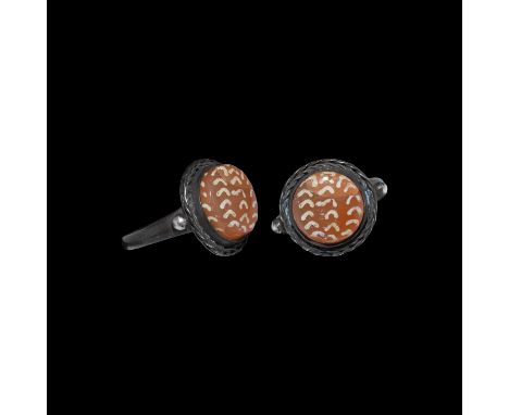 2nd century AD. A silver finger ring with narrow D-section hoop, applied granule to each shoulder, braided filigree collar an
