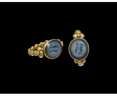 5th-7th century AD. An Arab-Sassanian nicolo intaglio gemstone with marriage scene, set into a later gold finger ring with ho