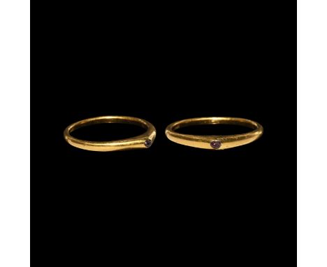 13th-14th century AD. A slender gold stirrup ring with flat-section hoop, pyramidal bezel with cabochon ruby to the apex. Cf.