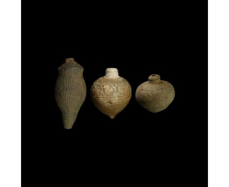 9th-11th century AD. A group of three hollow ceramic vessels each with conical body, intended to be filled with explosive liq