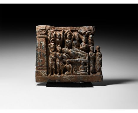 2nd-3rd century AD. A carved schist frieze fragment with Mahaparinirvana scene depicting the corpse of Buddha on a raised bed
